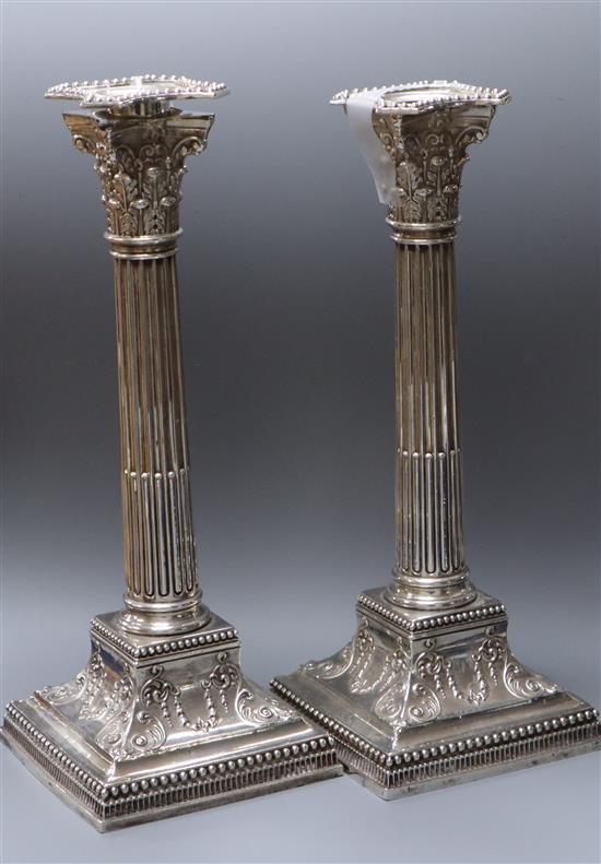 A pair of late Victorian silver corinthian column candlesticks, James Dixon & Sons, Sheffield, 1891 (one sconce a.f.), 27cm.